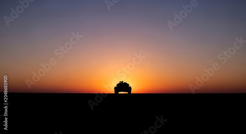 Silhouette of off road vehicle at sunset horizon with transparent background