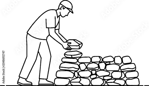 Construction worker building stone wall with cement.