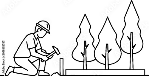 Gardener planting young trees with hammer and protective gear.