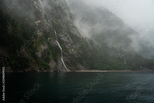 Misty mountains and waterfalls, New Zealand fjords, Milford