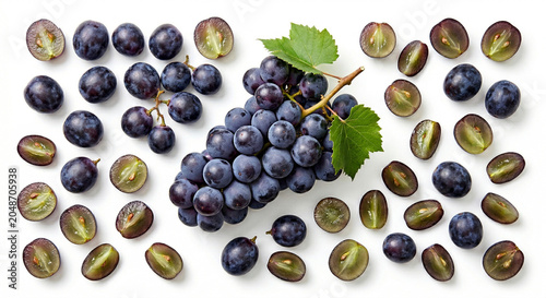 Fresh whole and quartered Concord grapes on white background