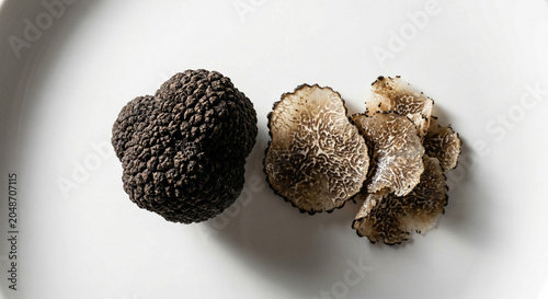 Fresh black truffle whole and sliced showing texture