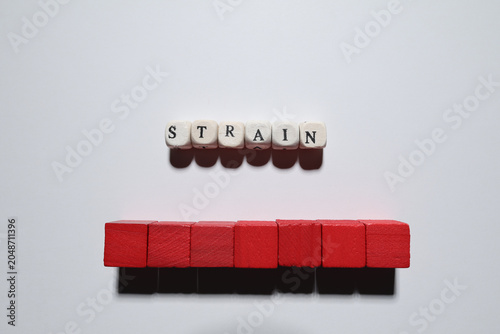 Virus strain concept using elongated red wooden block model on white background with copy space for healthcare and research themes.