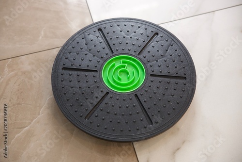 Canvastavla Black circular balance board with textured surface and bright green center for home fitness, balance training, core strengthening and physical therapy
