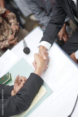 Formal handshake between two professionals sealing a successful business agreement during a corporate meeting