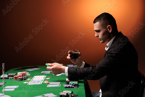 Bilde på lerret Man playing in dark casino, smoking cigar, drink whiskey