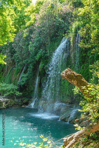 Scenic view of Kursunlu Waterfall and emerald water pond in Antalya nature park, Turkey.
