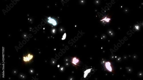 Colorful butterflies flying in slow motion against a dark background with sparkling lights