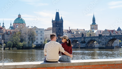 Obraz na płótnie Couple enjoying a romantic moment by the Vltava River in Prague, Czechia during