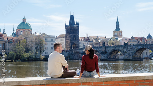 Couple enjoying a sunny day by the Vltava River in Prague, Czechia