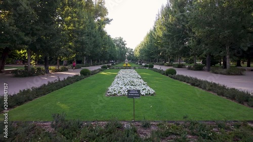 Gardens of the Retiro Park, with colorful flowers and lots of vegetation, at dawn in spring, Madrid.