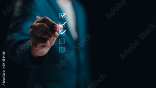 A Businessman online check survey filling out, digital form checklist satisfaction questionnaire and feedback report result of voting client. Business performance monitoring concept