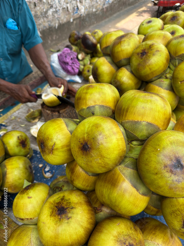 A man cutting palm fruit.this photo was taken from Chittagong, Bangladesh.