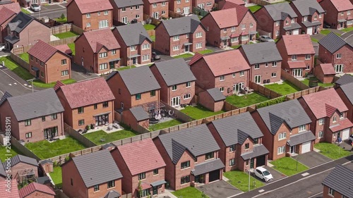 Rows of small new build houses show residential housing development properties, England