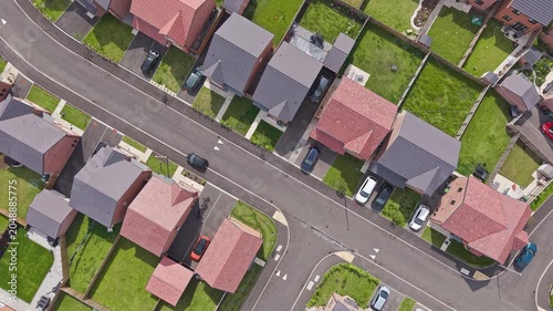 Aerial view, new build housing estate, residential houses along street with parked cars, England