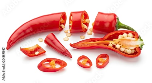 Several red chili peppers are shown, cut open to reveal their seeds. Some peppers are sliced into rounds, while others are halved.