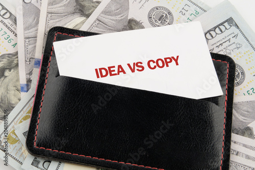 Fényképezés In a sleek wallet, a card boldly states the phrase Idea vs Copy, symbolizing the