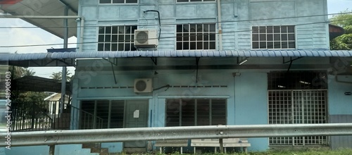 Light Blue Industrial Building with Air Conditioning Units