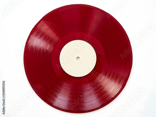 Translucent crimson colored vinyl LP record disc displaying glossy grooved textures centered on a bright white backdrop canvas.