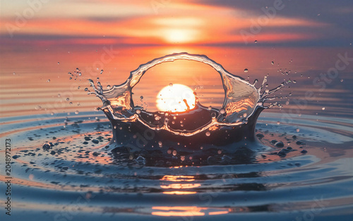 As the golden sun sinks toward the horizon, a mesmerizing splash erupts from the calm water, perfectly framing the glowing orb within a crystalline arc. Droplets, frozen in midair, glisten like
