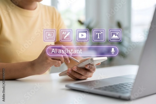 Person using smartphone and laptop with holographic ai assistant interface displayed