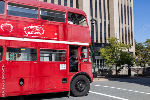 Canvas Print Vintage red double decker sightseeing bus travelling through downtown Halifax No
