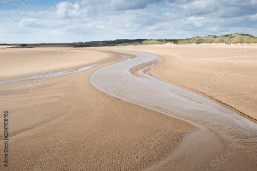 Photos A deserted beach in Burry Port South Wales at low tide reveals rippling channels
