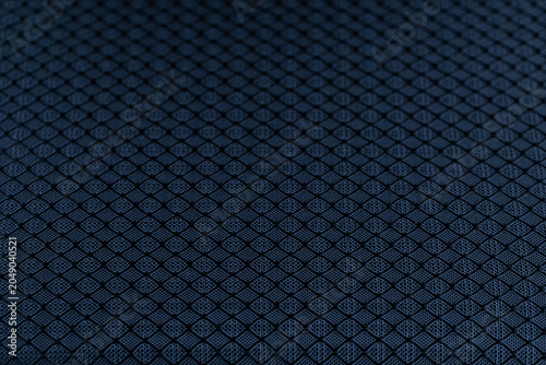 Dark blue textured nylon fabric with geometric diamond pattern macro view
