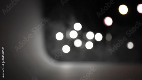 Blurred view of lights and an interior architectural detail with a dark background and ambient sounds