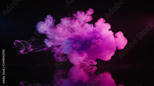 Vibrant pink smoke cloud floating in black empty space.