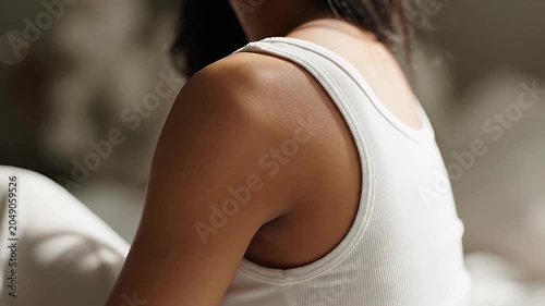 Close-up profile of woman neck and shoulder.