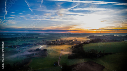 Εκτύπωση καμβά "Aerial Drone View of Bavarian Village at Sunrise with Morning Fog — Rural Lands