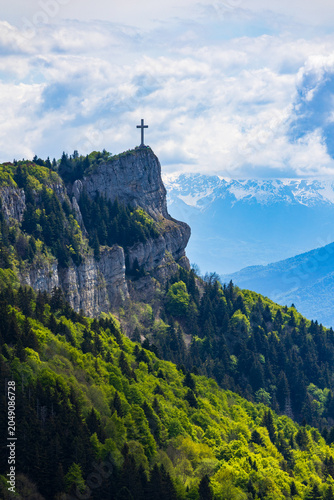Panoramic view of the Croix du Nivolet overlooking the city of Chambéry from the top of its limestone cliff seen from the Alpage du Sire