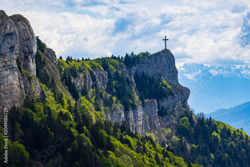 Panoramic view of the Croix du Nivolet overlooking the city of Chambéry from the top of its limestone cliff seen from the Alpage du Sire