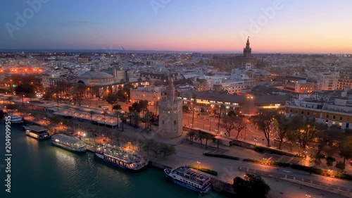 Aerial glimpse of Seville at sunset. Golden hour illuminates historic Seville city and architecture