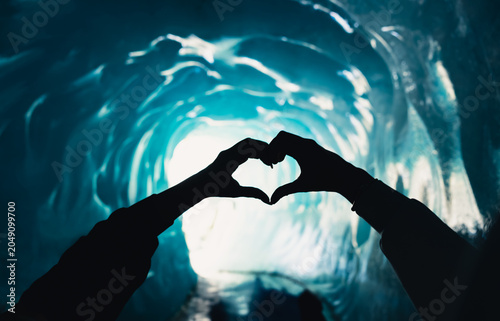 Heart shaped hands inside Mer de Glace ice cave in Chamonix Mont Blanc, France
