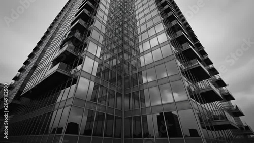 Low Angle Black and White View of a Modern Skyscraper with Reflections and Overcast Skies