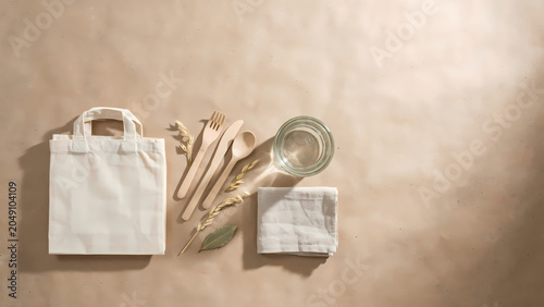 Eco friendly reusable bag with wooden cutlery and glass of water on beige background transparent background