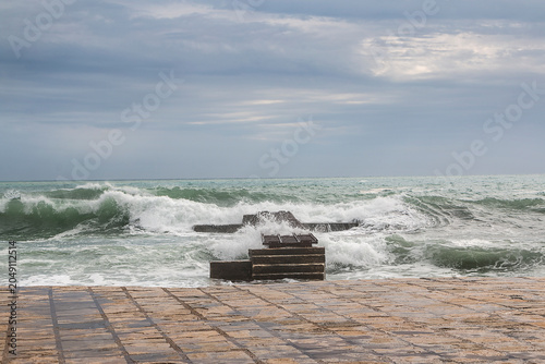 Stormy sea with high waves and a platform