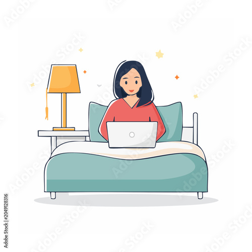 Woman working on laptop in bed with bedside lamp