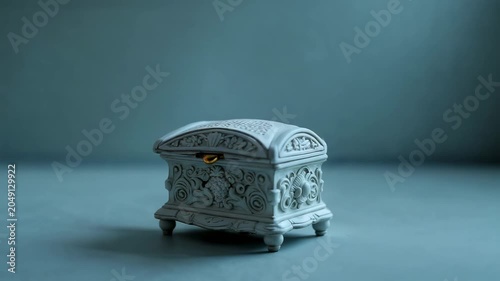 Beautiful music box with intricate design plays soft tunes on a table in a dim room