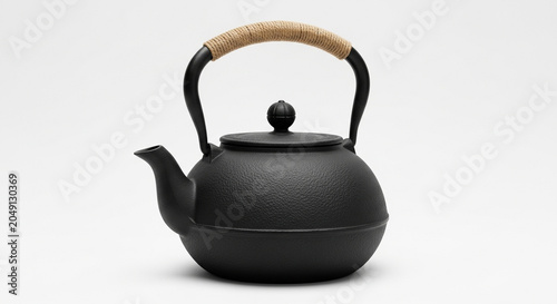 Vintage cast iron tea kettle with bamboo handle on white background minimalist still life