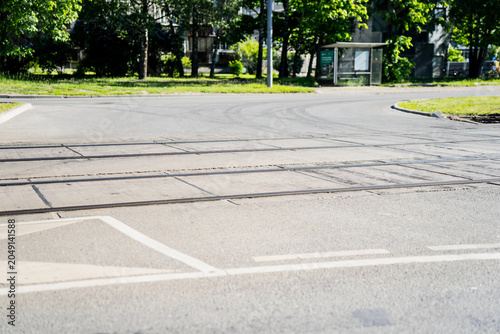 Fotografie Public transport tram tracks embedded into a concrete and asphalt street surface