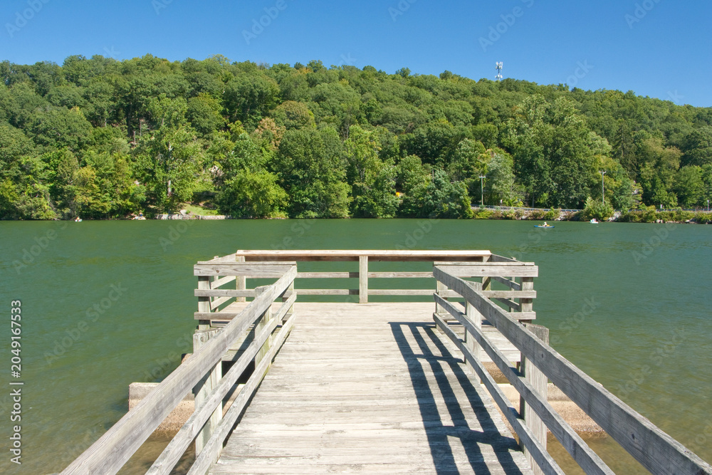 Obraz premium A dock extends onto the waters of Squantz Pond