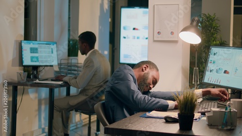 Photos Drowsy accountant sleeping in office, being woken up by colleague shocking him