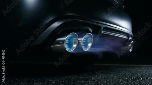Sports Car Dual Exhaust Pipes Firing Blue Orange Flame Burst at Night