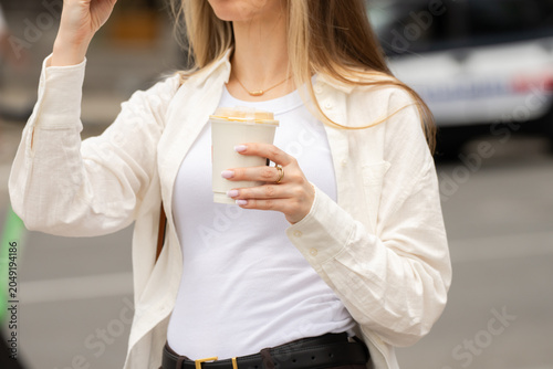 Person taking a relaxing break while drinking coffee, enjoying a moment of rest and calm during a busy day in a comfortable environment.