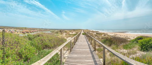 Valokuva Panoramic view of a wooden boardwalk stretching between lush coastal greenery an