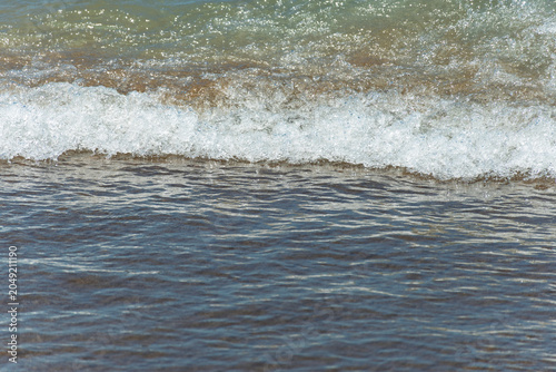 Foam from the waves on the seashore.