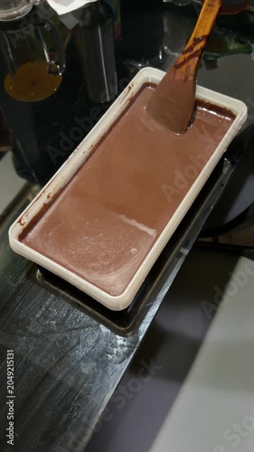chocolate cake batter is poured into the cake pan